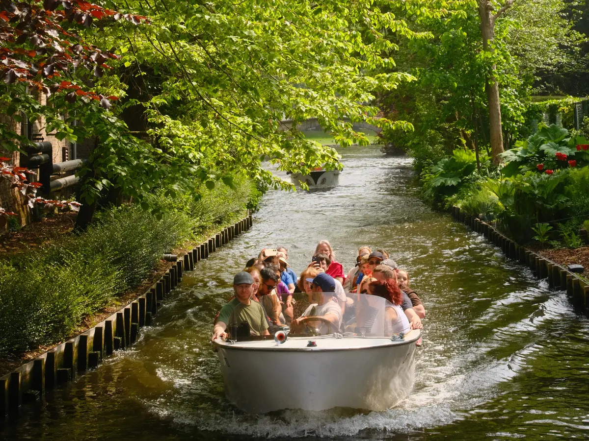 A boat full of tourists on the canals of Bruges